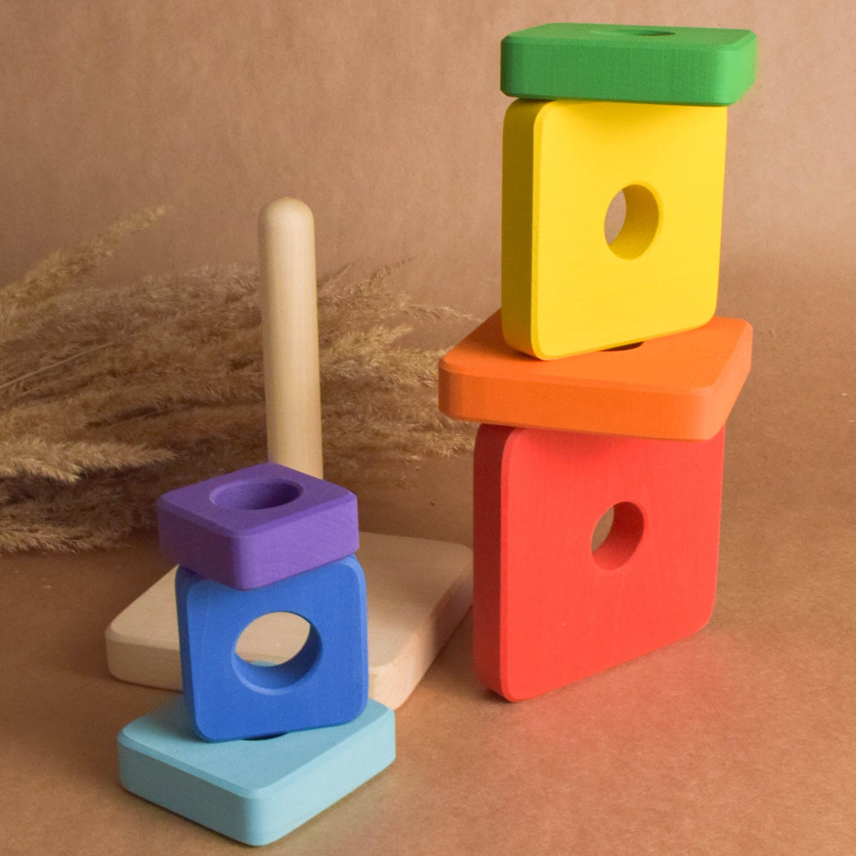 Wooden ring stacker with rainbow-colored square rings