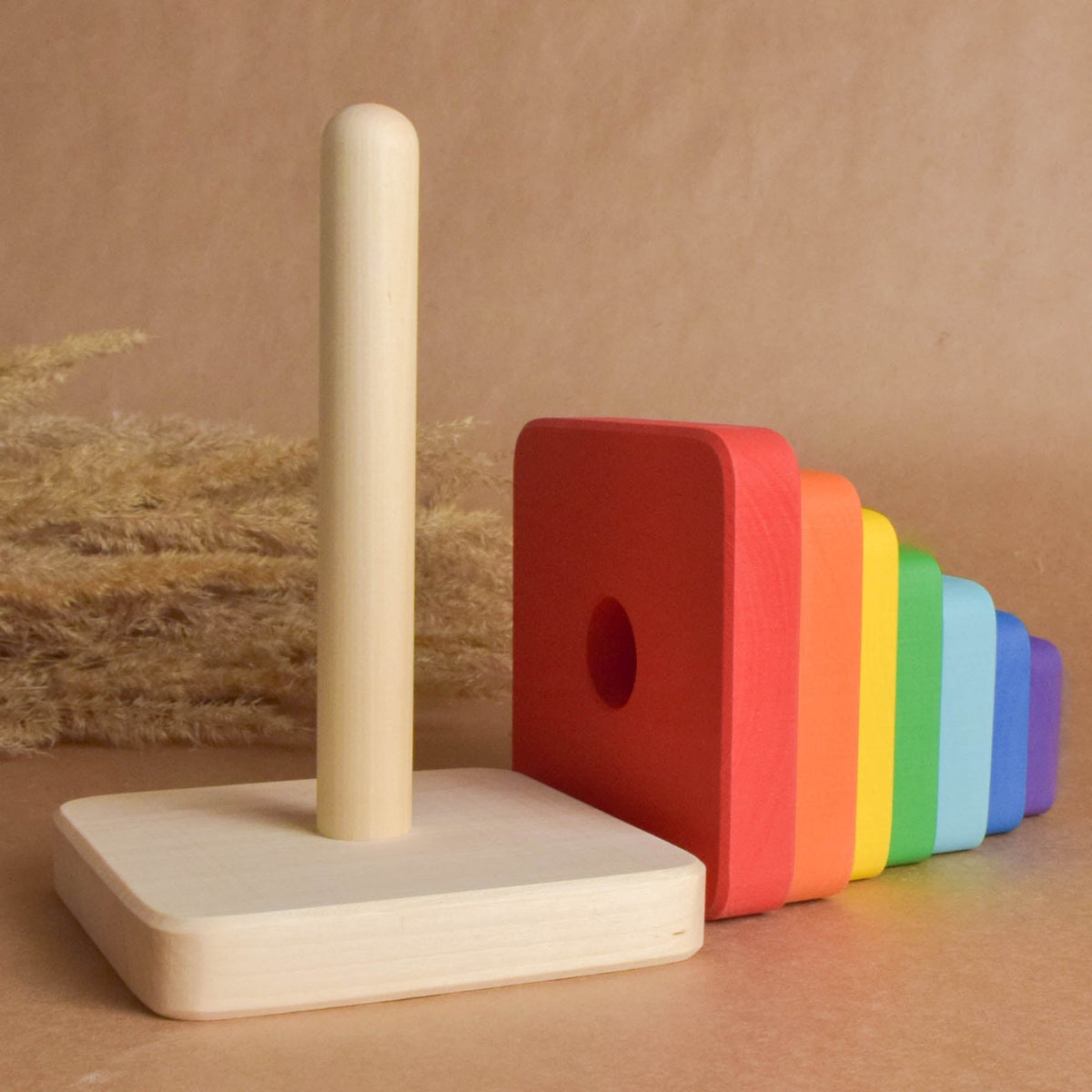 Wooden ring stacker with rainbow-colored square rings