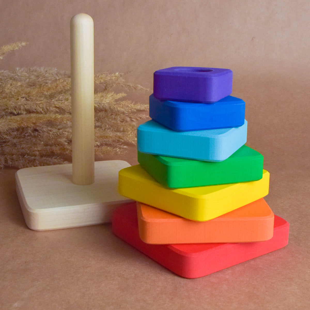 Ring stacking toy made from wood, with rainbow-colored square rings