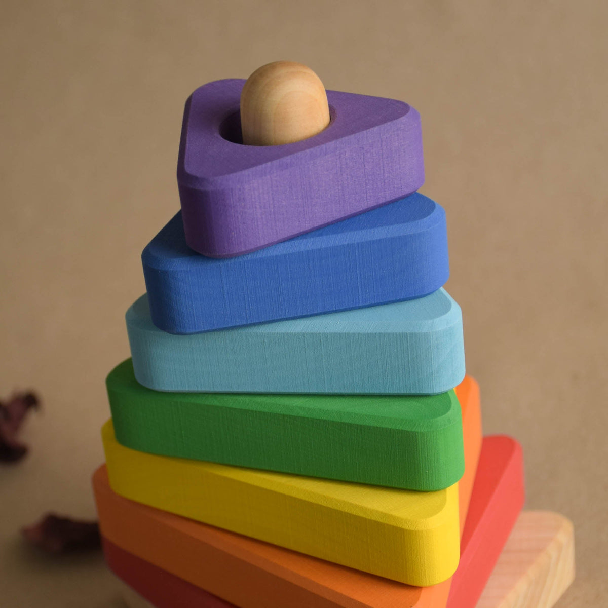 Wooden ring stacker with rainbow-colored triangular rings