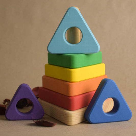 Wooden stacking toy with rainbow-colored triangular rings