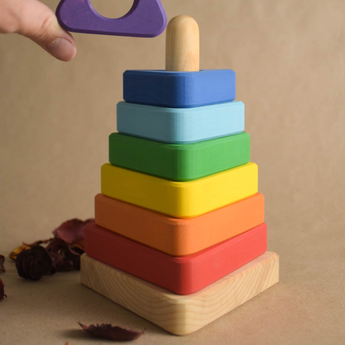 Wooden stacking rings toy with rainbow-colored triangular rings
