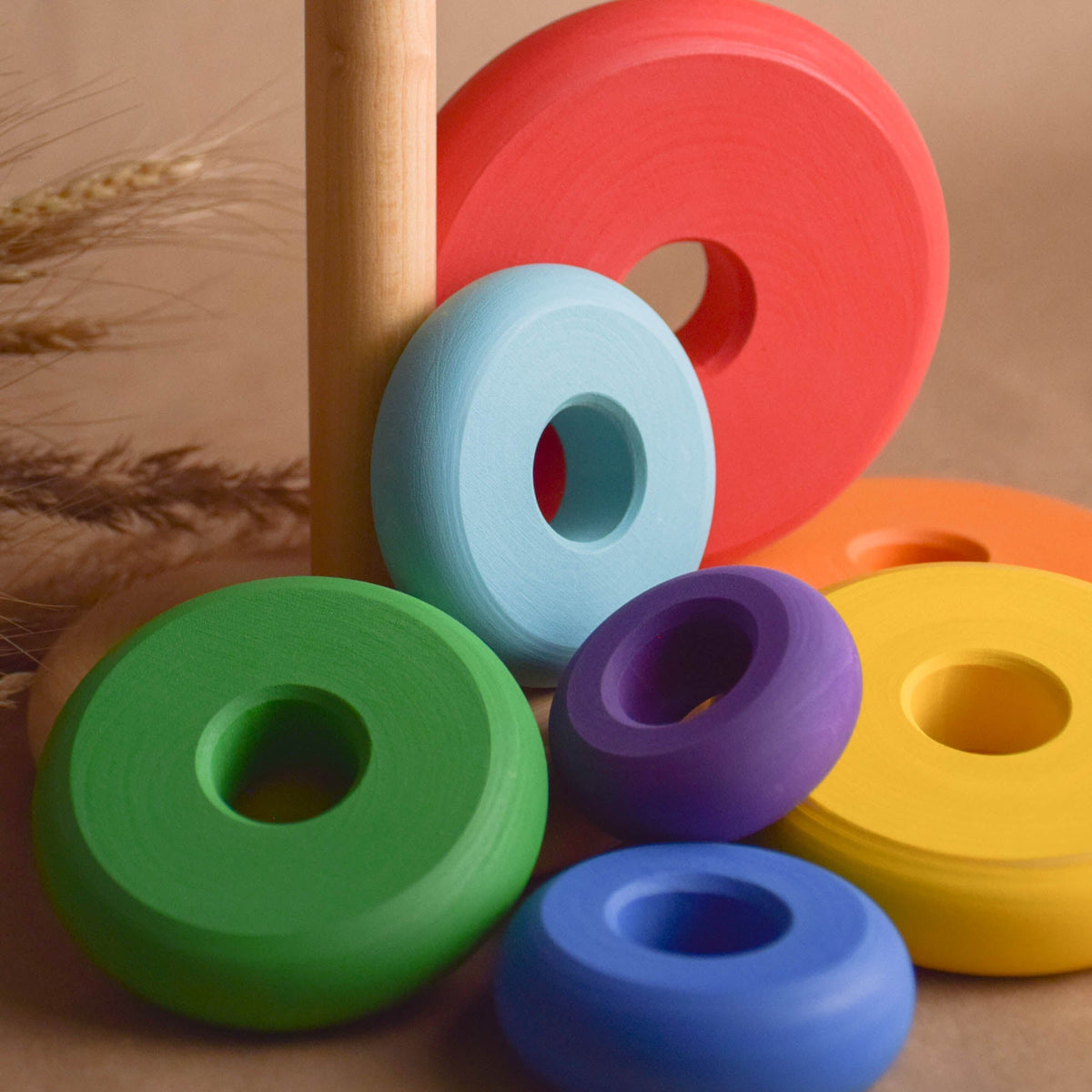 Wooden stacking rings toy with rainbow-colored turned rings