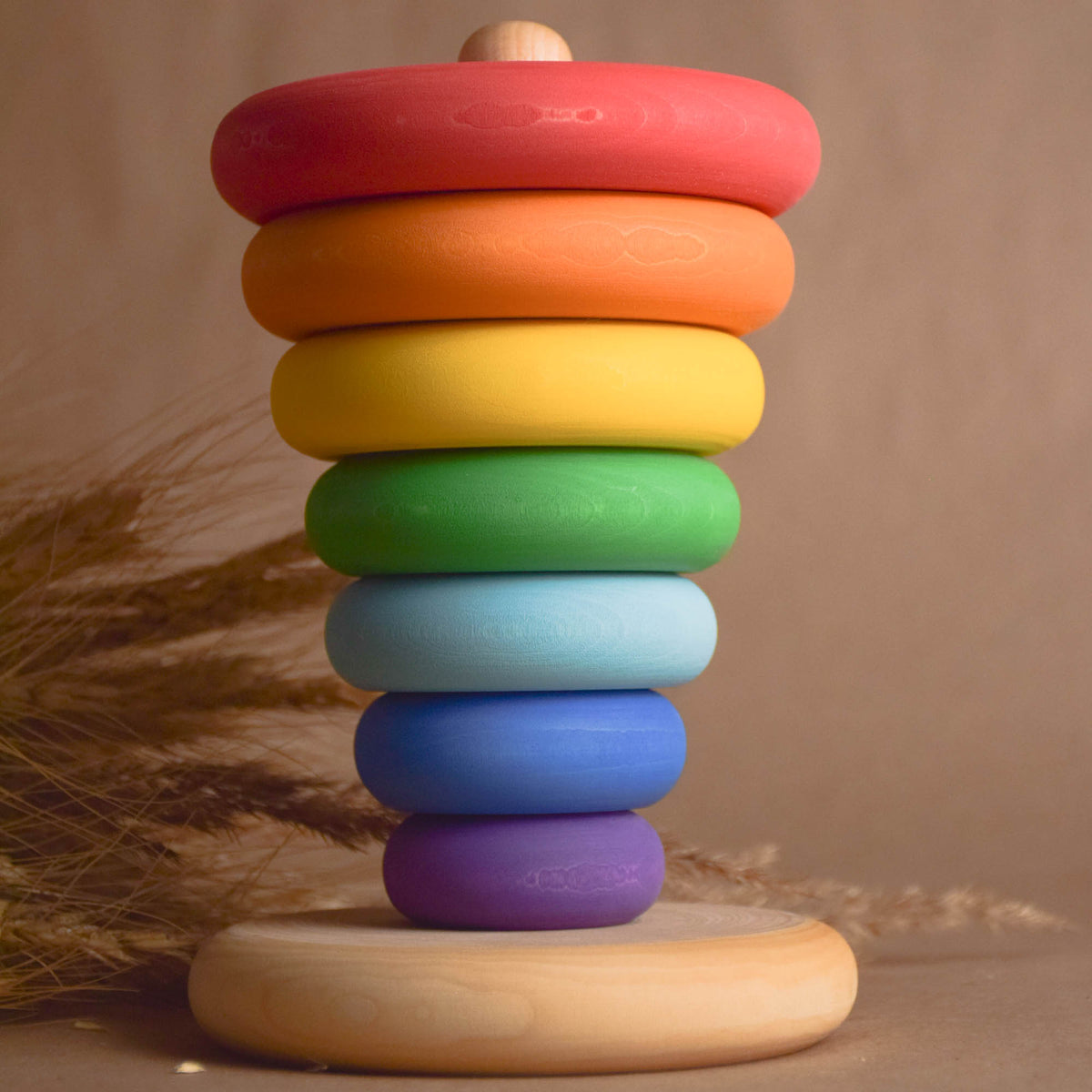 Wooden ring stacker with rainbow-colored turned rings