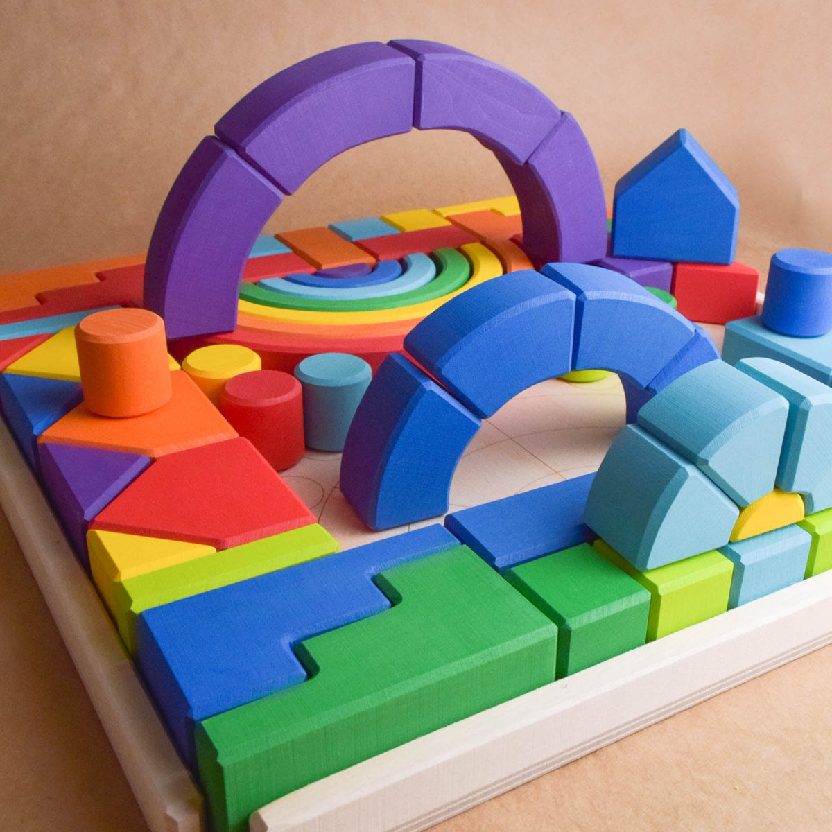 Close product view of the Rainbow Romanesque Building Set wooden rainbow stacker, finished with natural colored wax.