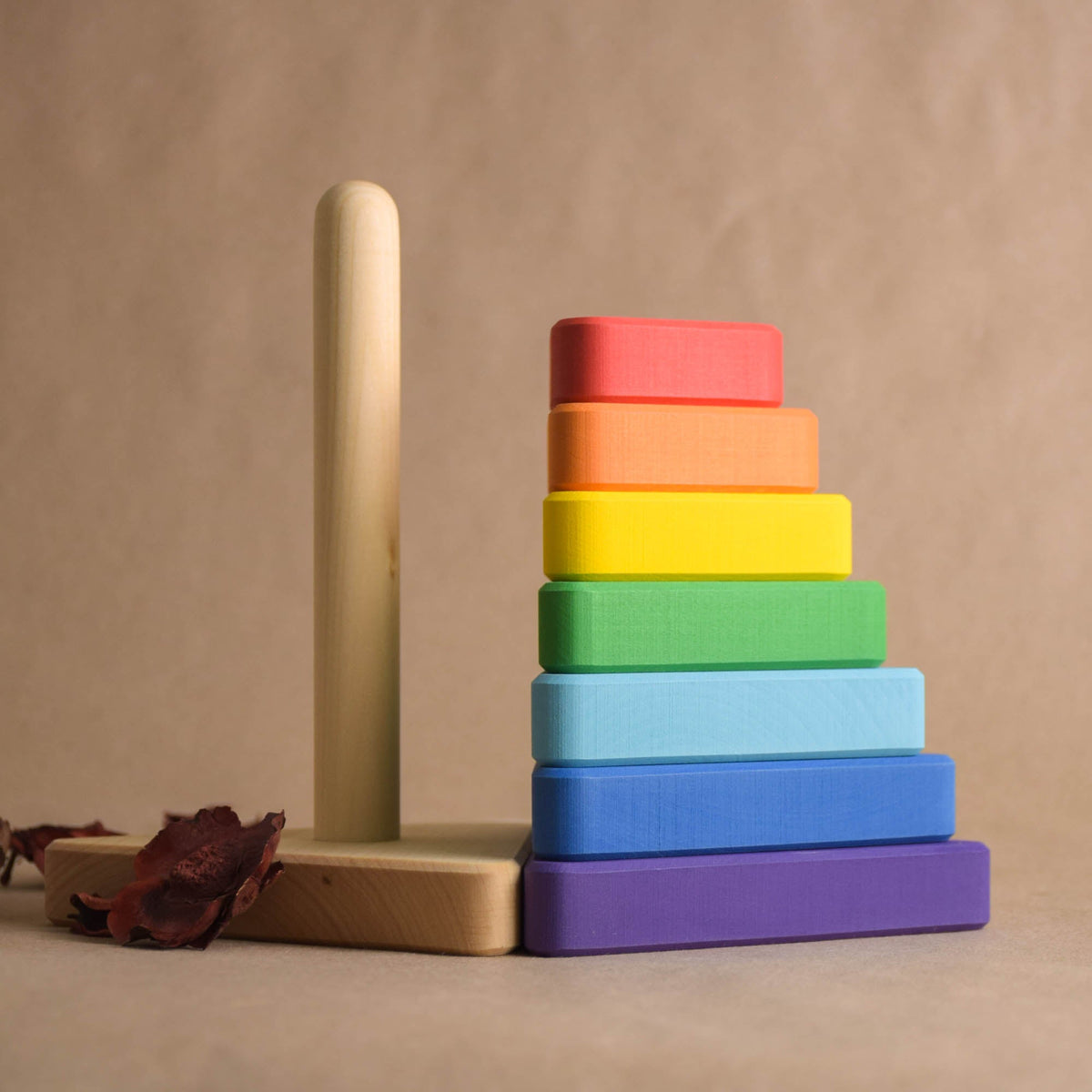 Wooden stacking toy with triangular rings