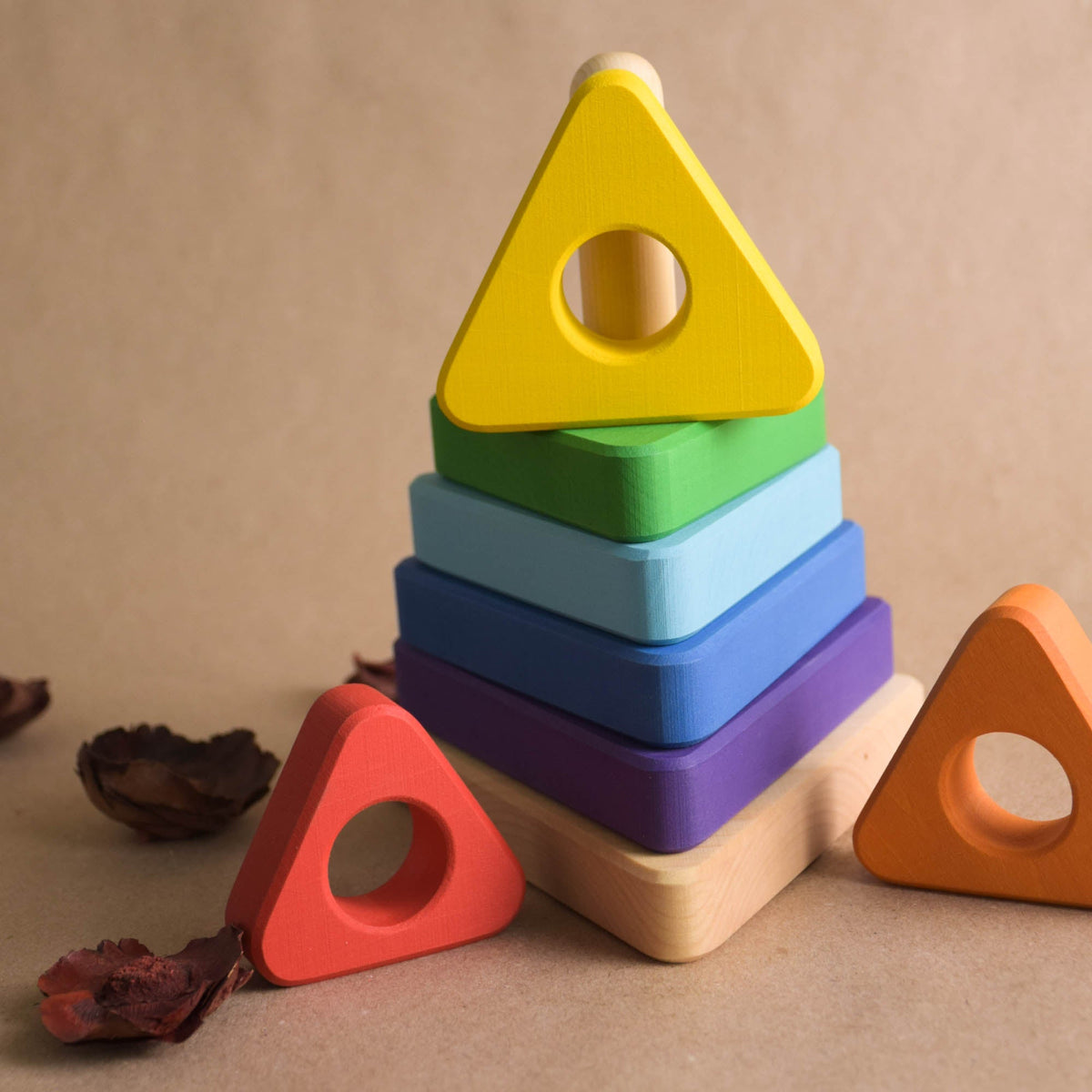 Wooden stacking toy with triangular rings