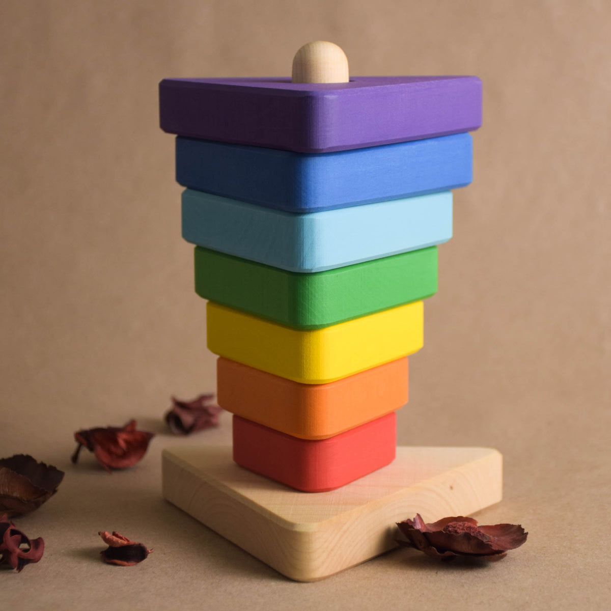 Stacking toy with triangular rings made from wood