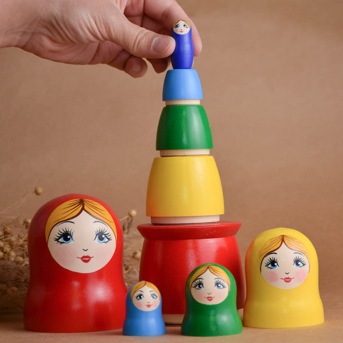 Rainbow matryoshka figures made from solid wood