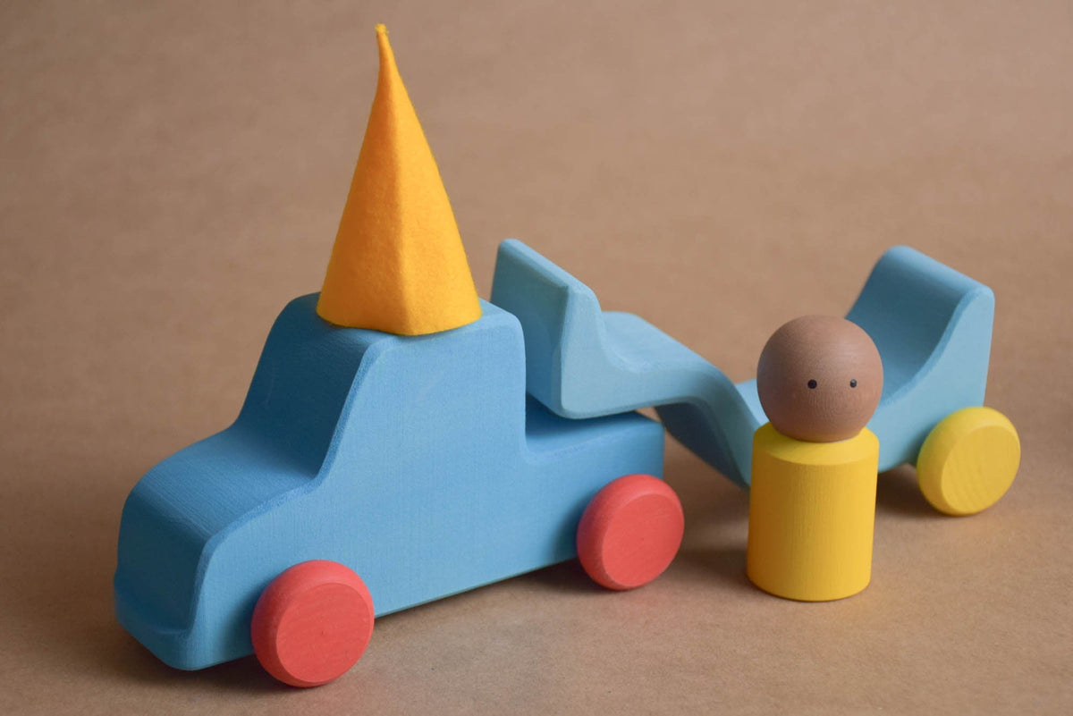 Wooden car transporter set with a car, trailer, and peg dolls