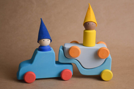 Wooden car transporter set with a car, trailer, and peg dolls
