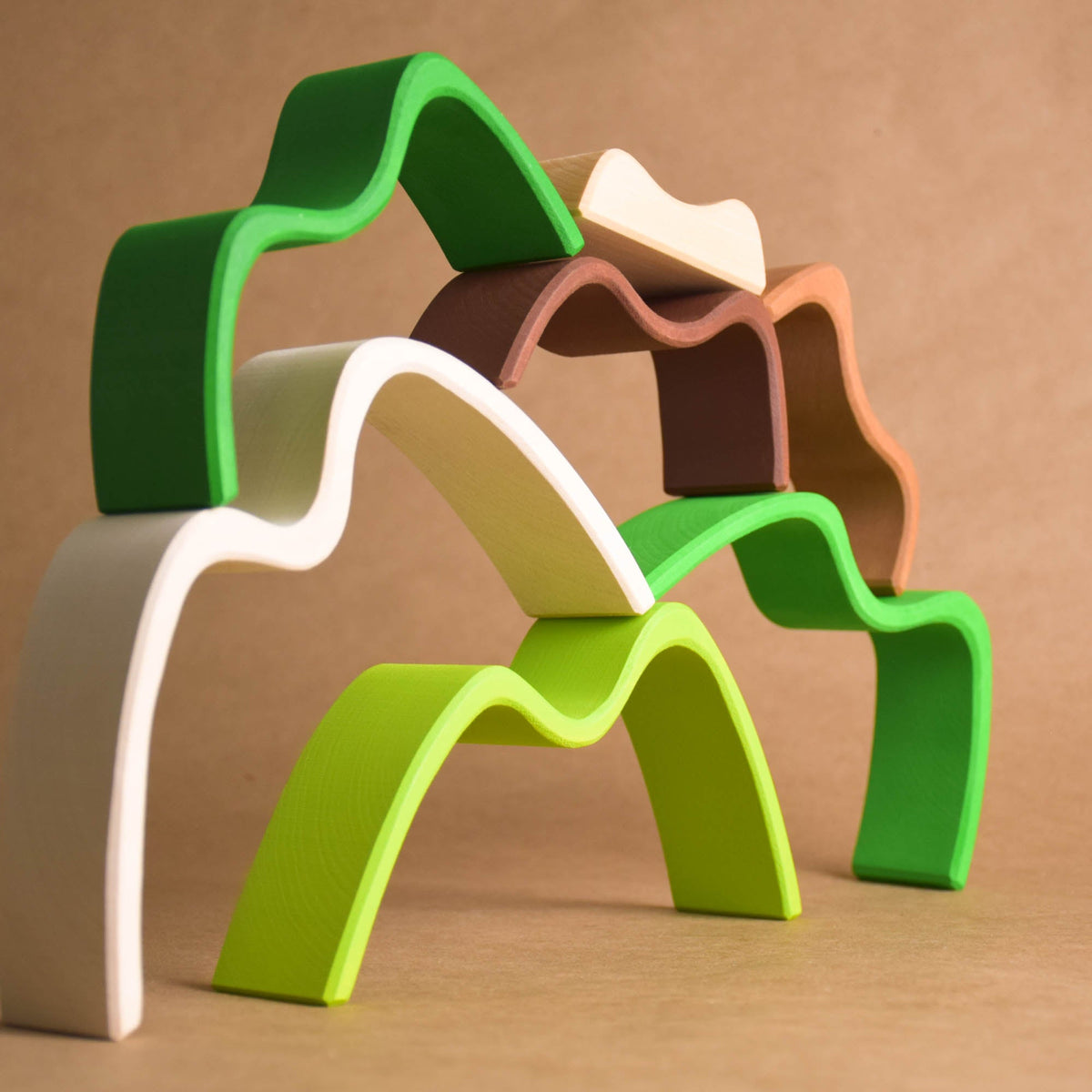 Handmade Montessori colored mountain stacking toy in linden wood with a natural wax-and-oil finish