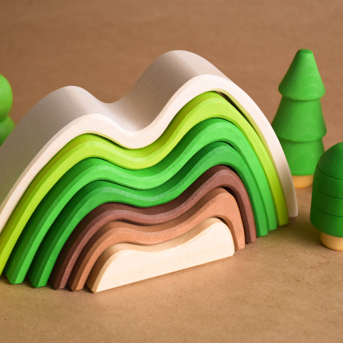 Handmade Montessori colored mountain stacking toy in linden wood with a natural wax-and-oil finish
