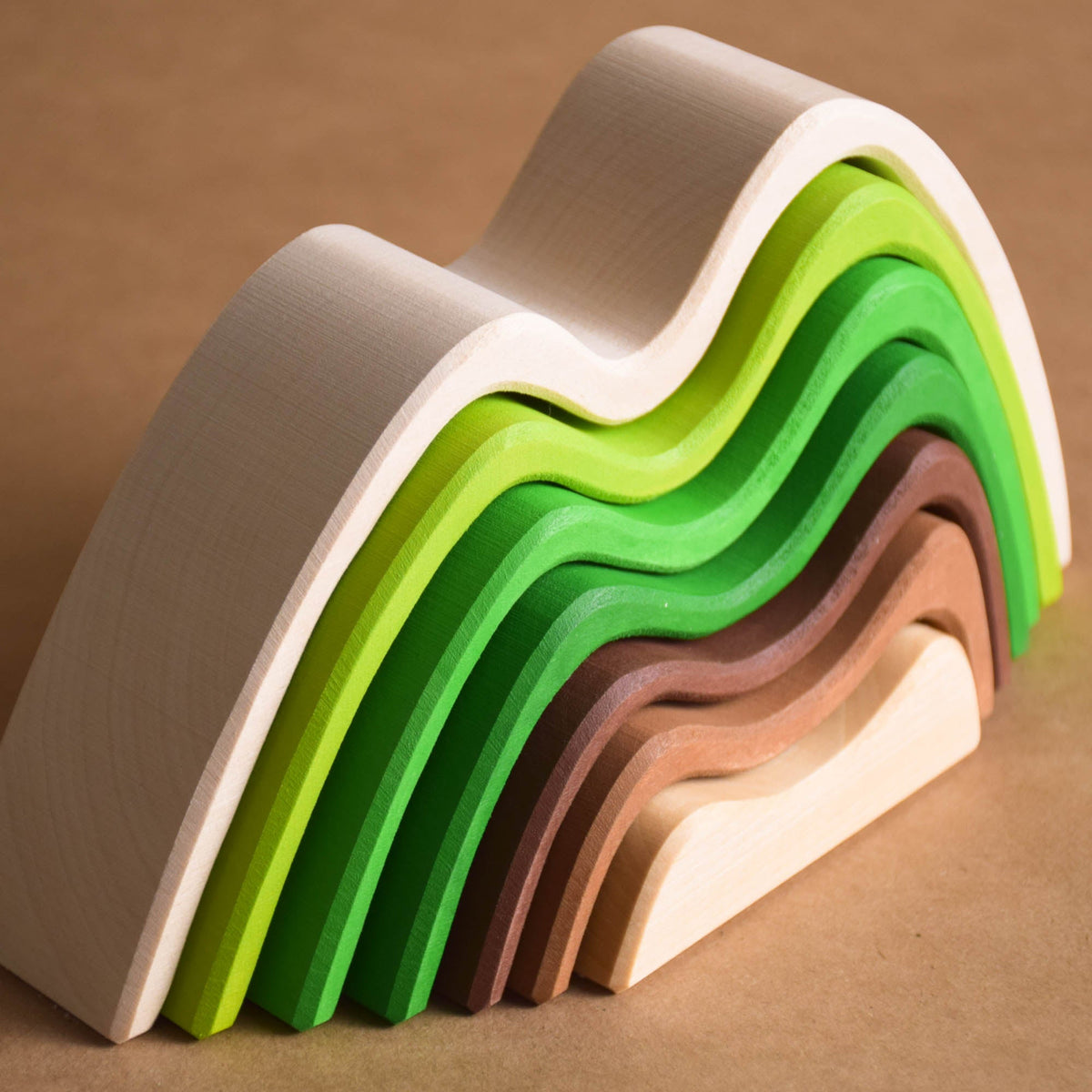 Handmade Montessori colored mountain stacking toy in linden wood with a natural wax-and-oil finish