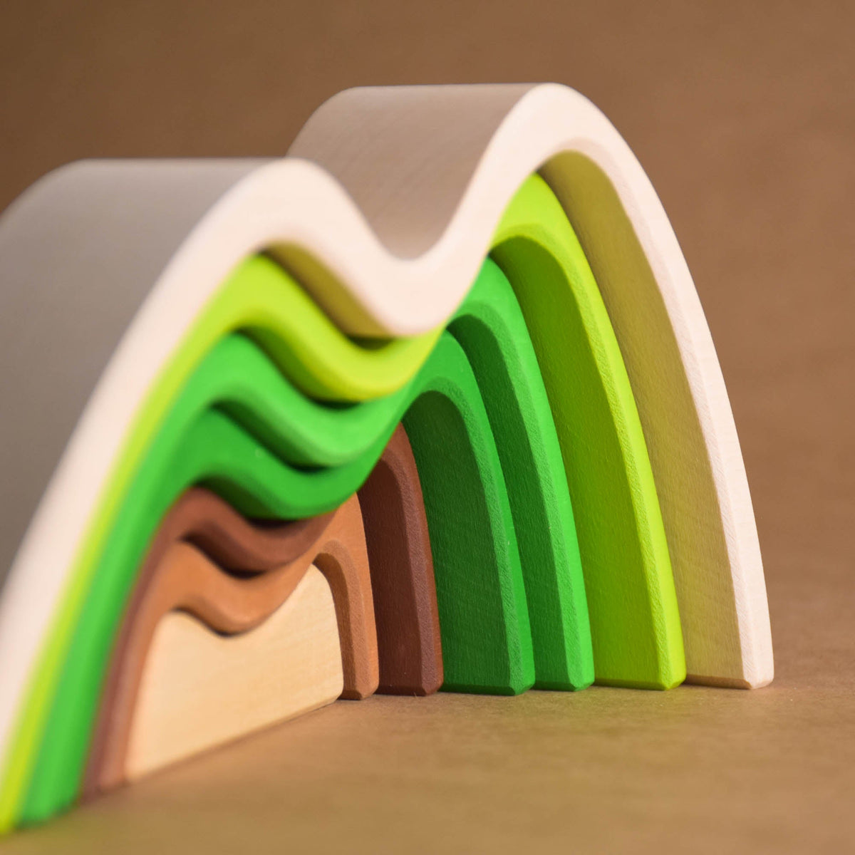 Handmade Montessori colored mountain stacking toy in linden wood with a natural wax-and-oil finish