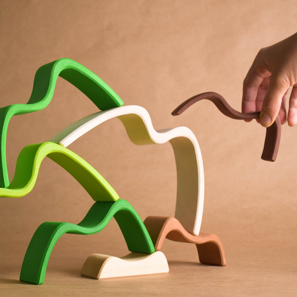 Handmade Montessori colored mountain stacking toy in linden wood with a natural wax-and-oil finish