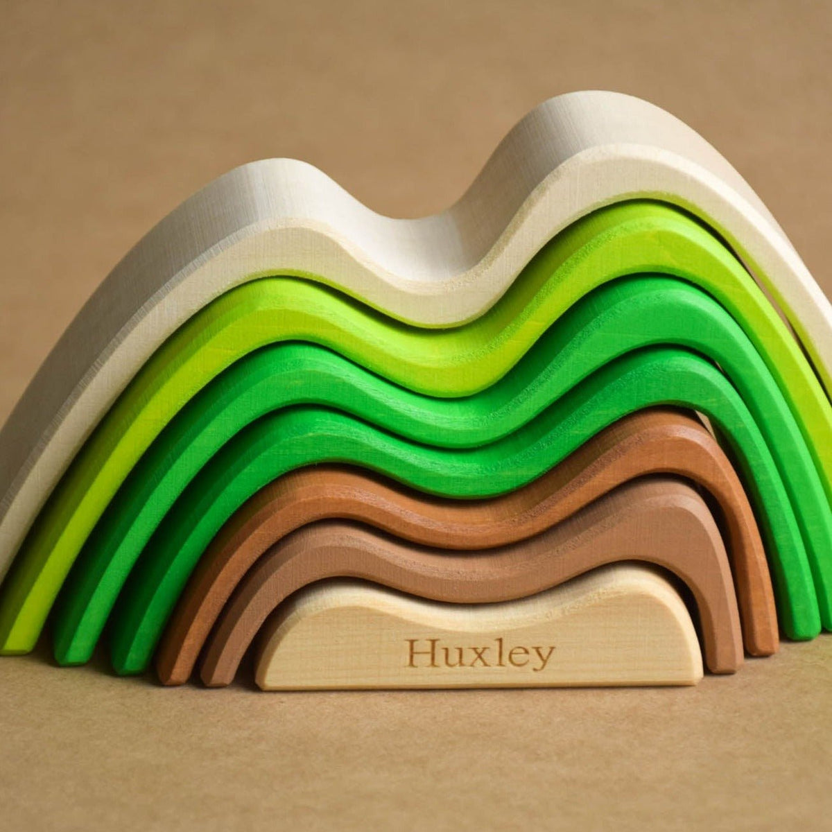 Handmade Montessori colored mountain stacking toy in linden wood with a natural wax-and-oil finish