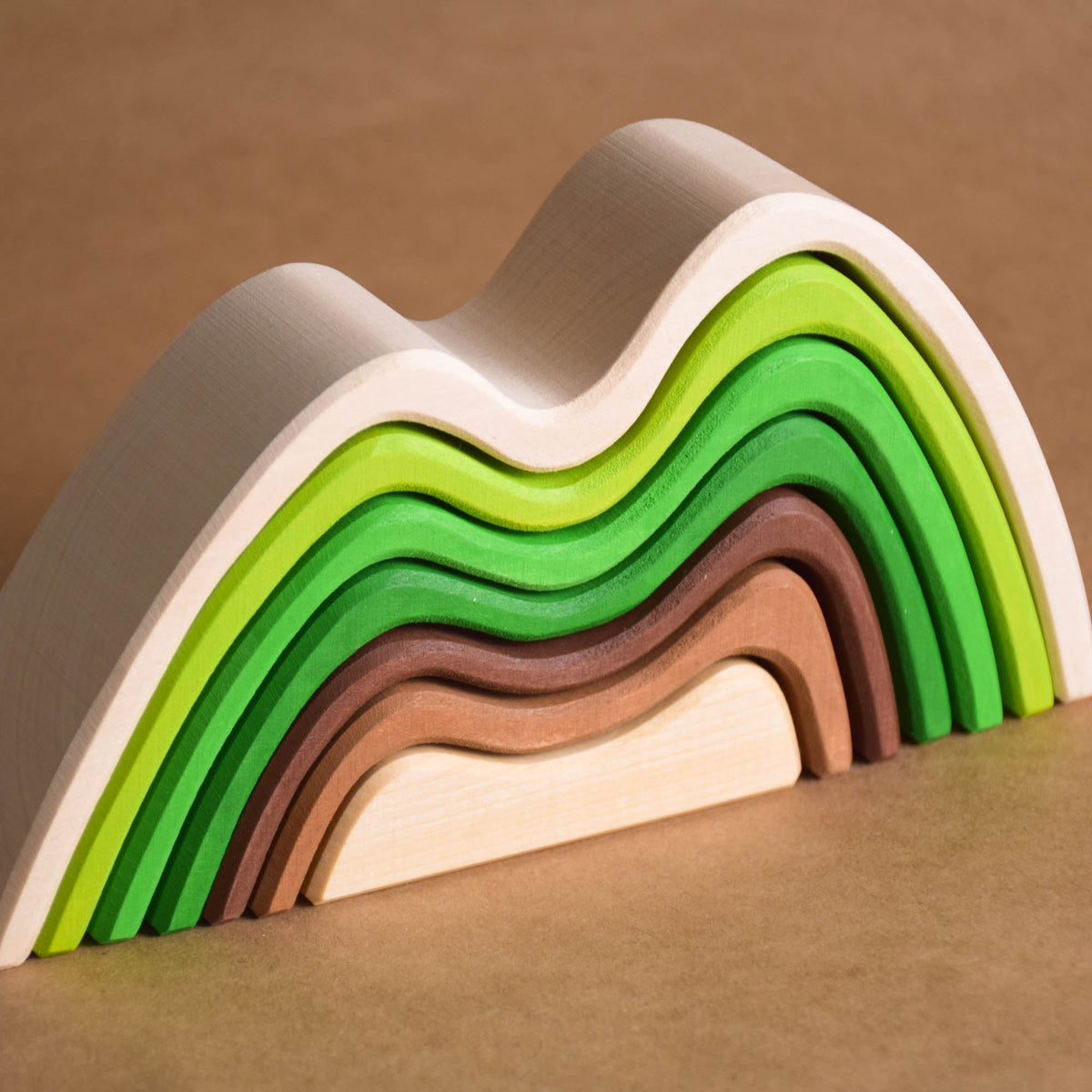 Handmade Montessori colored mountain stacking toy in linden wood with a natural wax-and-oil finish
