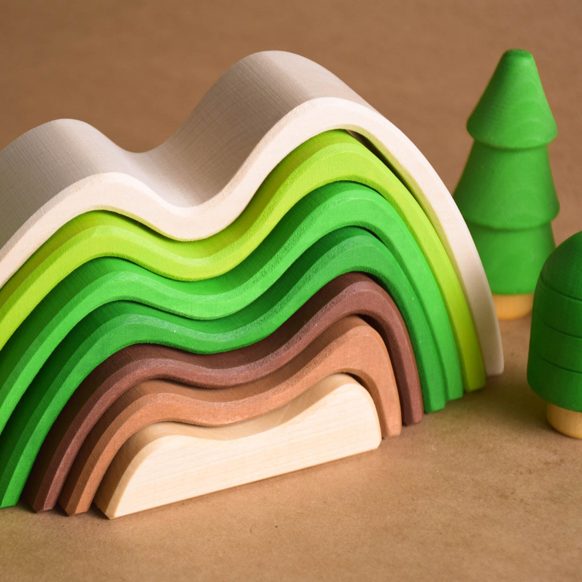 Handmade Montessori colored mountain stacking toy in linden wood with a natural wax-and-oil finish