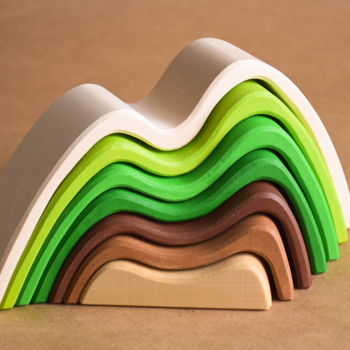 Handmade Montessori colored mountain stacking toy in linden wood with a natural wax-and-oil finish