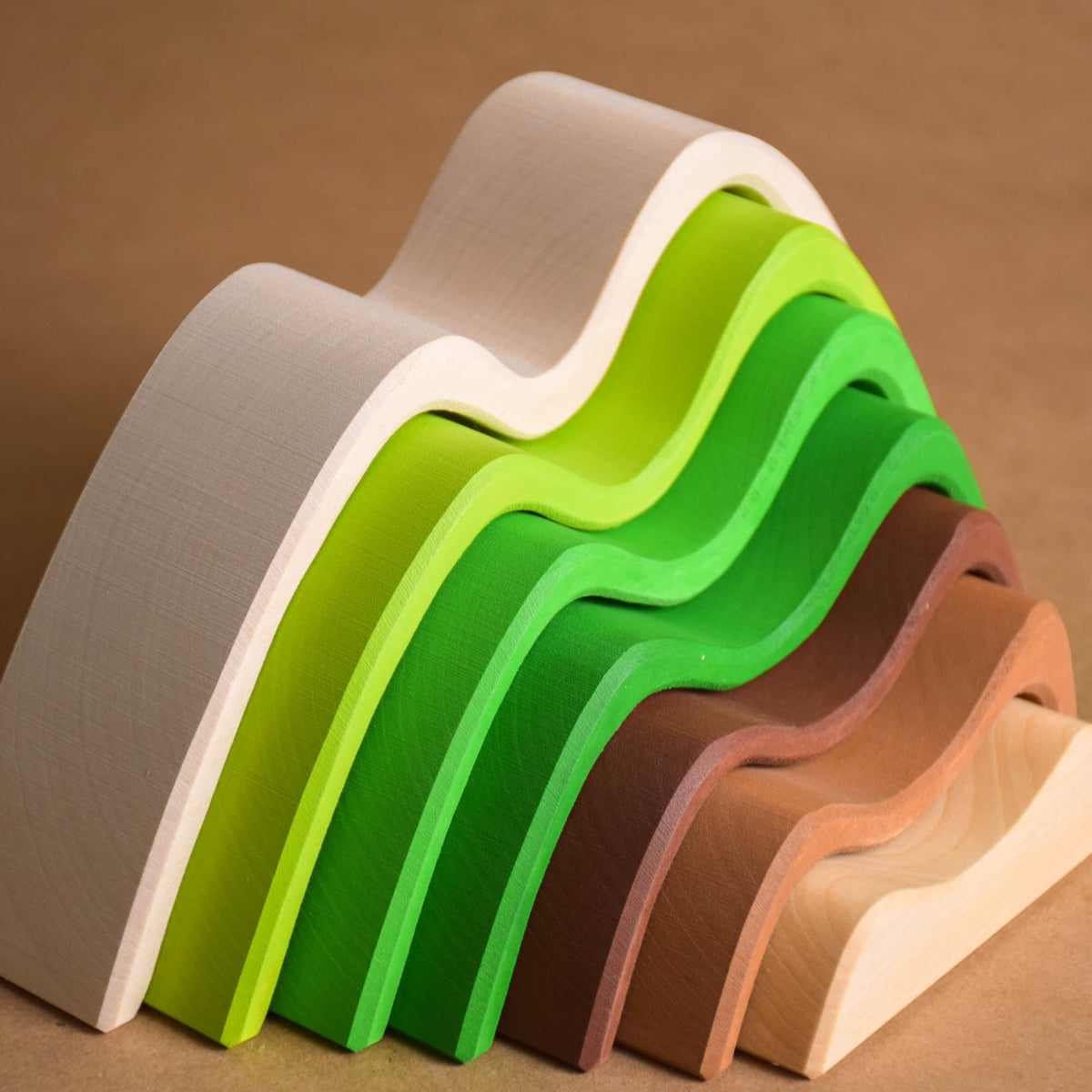 Handmade Montessori colored mountain stacking toy in linden wood with a natural wax-and-oil finish