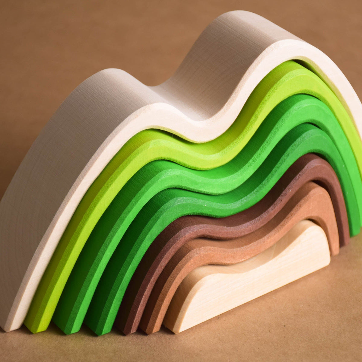 Handmade Montessori colored mountain stacking toy in linden wood with a natural wax-and-oil finish