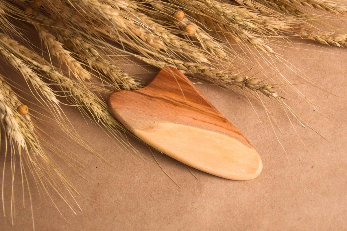 Elm wood facial massage tool with a heart-shaped design