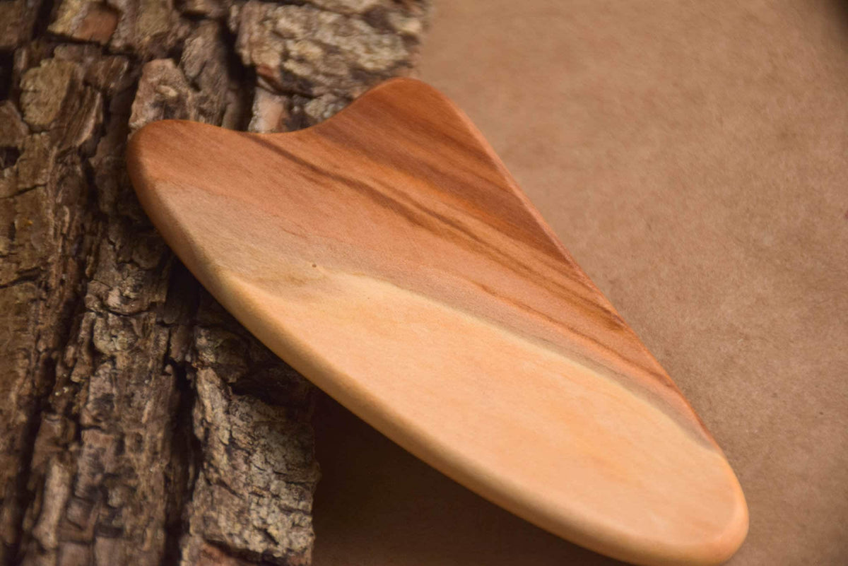 Heart-shaped gua sha tool crafted from elm wood