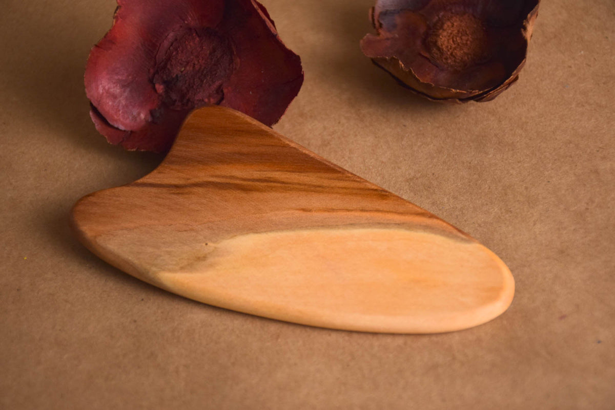Wooden gua sha facial massage tool made from elm