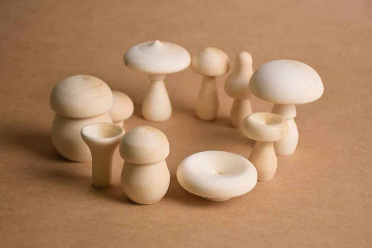 Ten unfinished wooden mushrooms