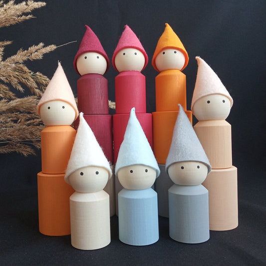 Neutral-colored wooden peg dolls with hats and cups