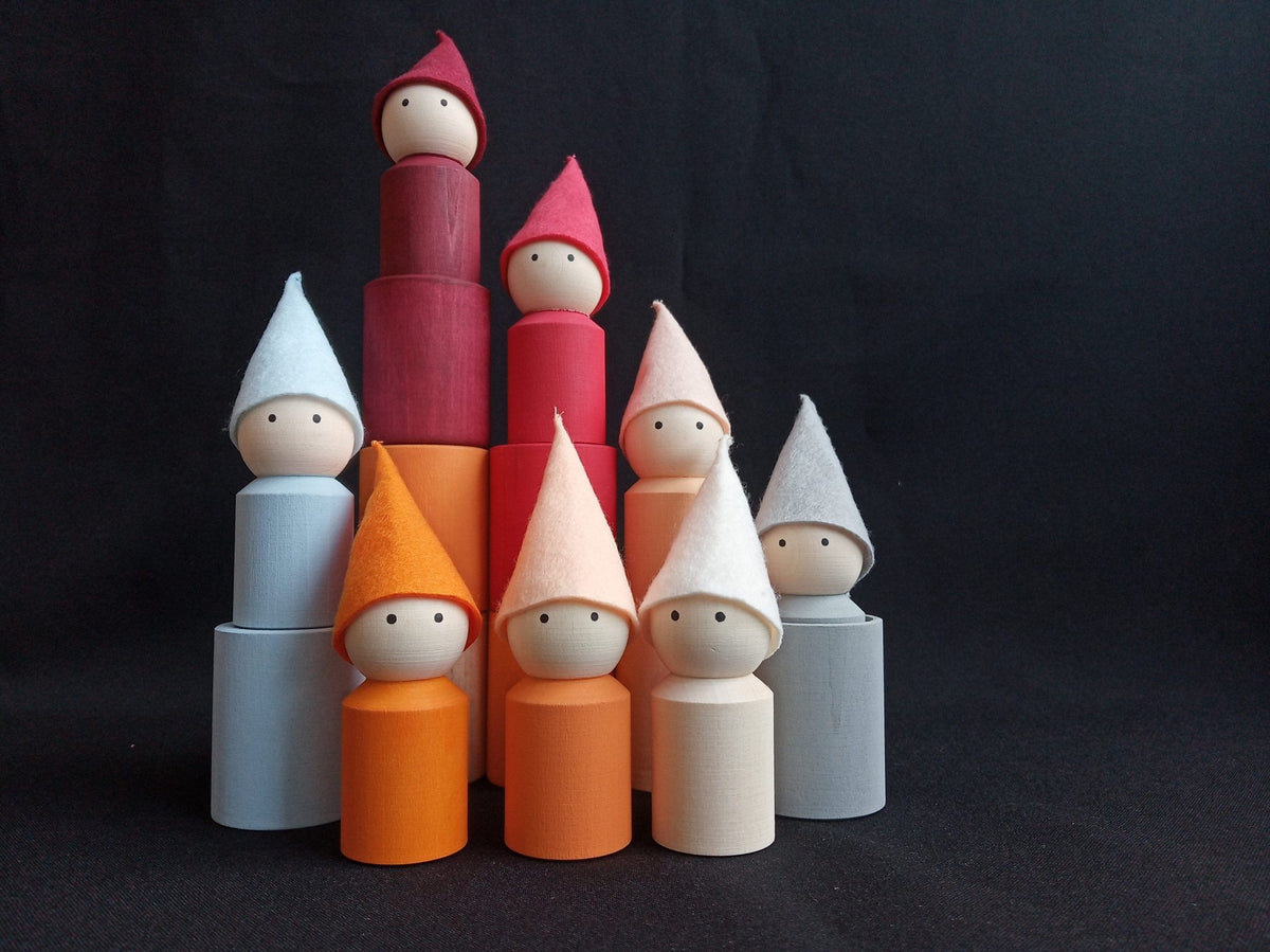 Neutral-colored wooden peg dolls with hats and cups