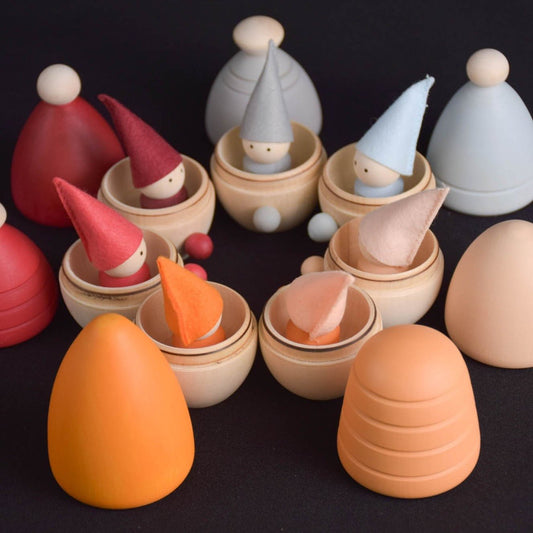 Neutral-colored wooden peg dolls with opening houses