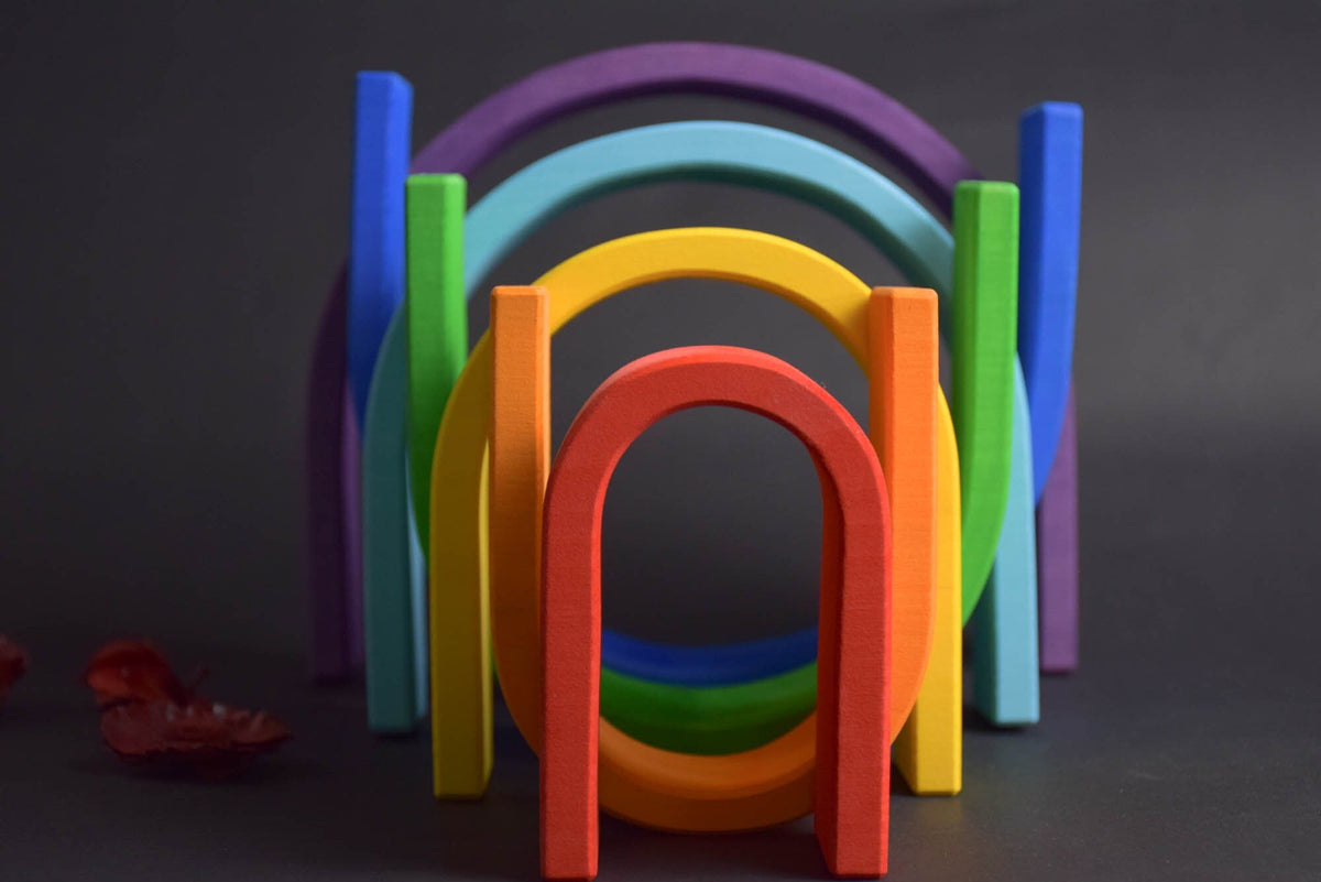 Handmade Montessori oval rainbow stacker in linden wood with a natural colored wax-and-oil finish