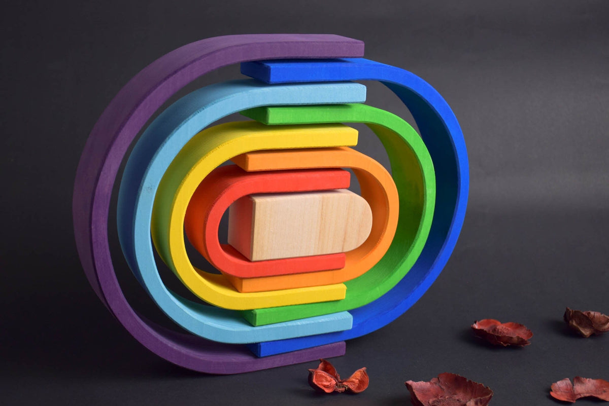 Handmade Montessori oval rainbow stacker in linden wood with a natural colored wax-and-oil finish