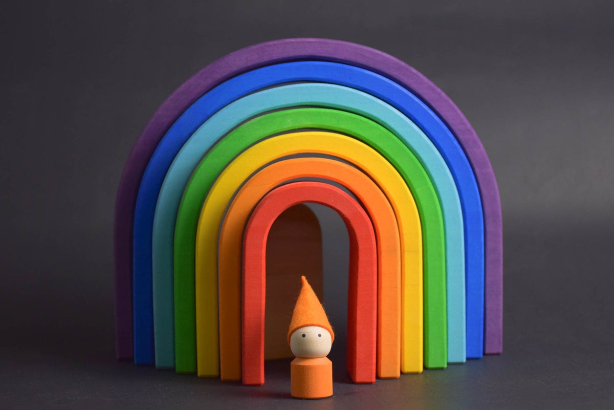 Handmade Montessori oval rainbow stacker in linden wood with a natural colored wax-and-oil finish