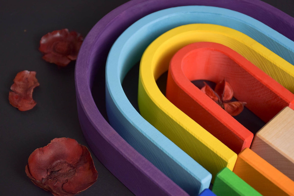 Handmade Montessori oval rainbow stacker in linden wood with a natural colored wax-and-oil finish