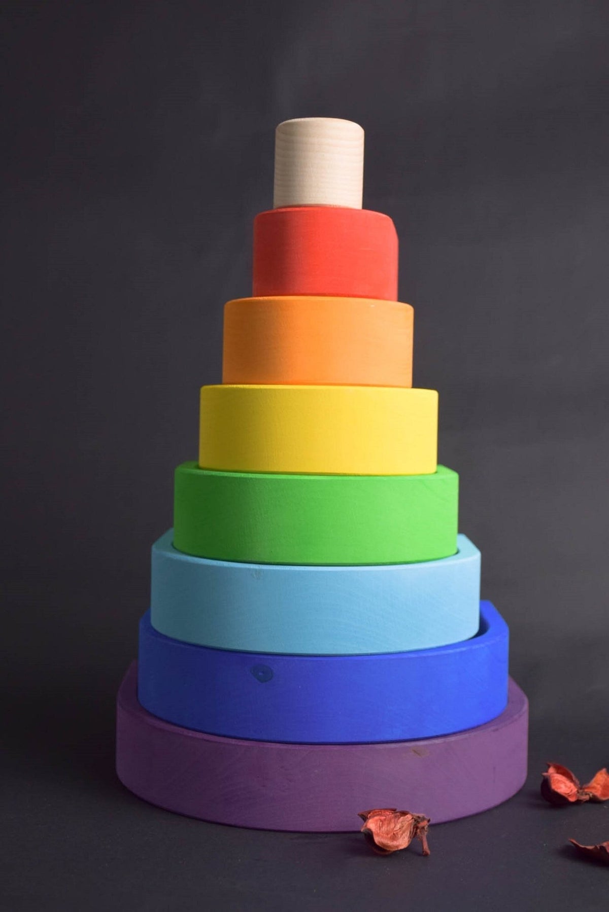 Handmade Montessori oval rainbow stacker in linden wood with a natural colored wax-and-oil finish