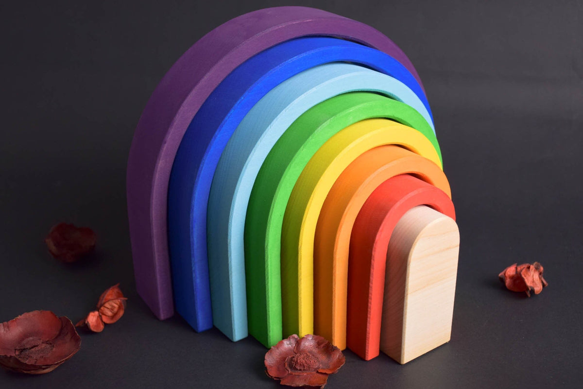 Handmade Montessori oval rainbow stacker in linden wood with a natural colored wax-and-oil finish