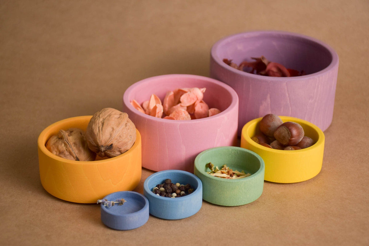Wooden nesting bowls in pastel colors