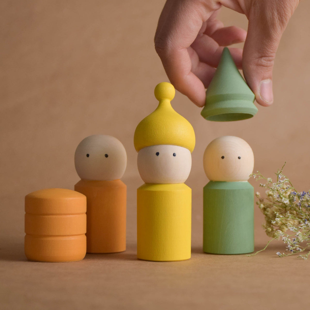 Pastel peg doll family with opening hats