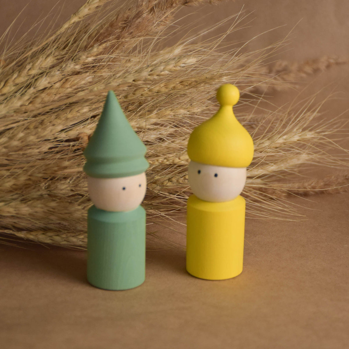 Wooden peg doll set with soft pastel hats