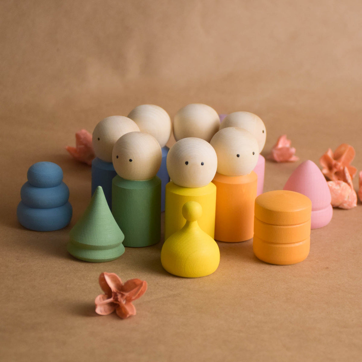 Wooden peg dolls with pastel-colored hats