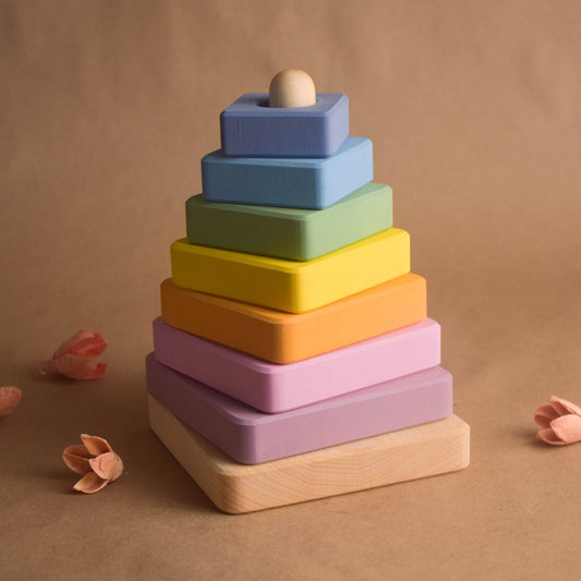 Linden wood stacking toy with pastel-colored square rings