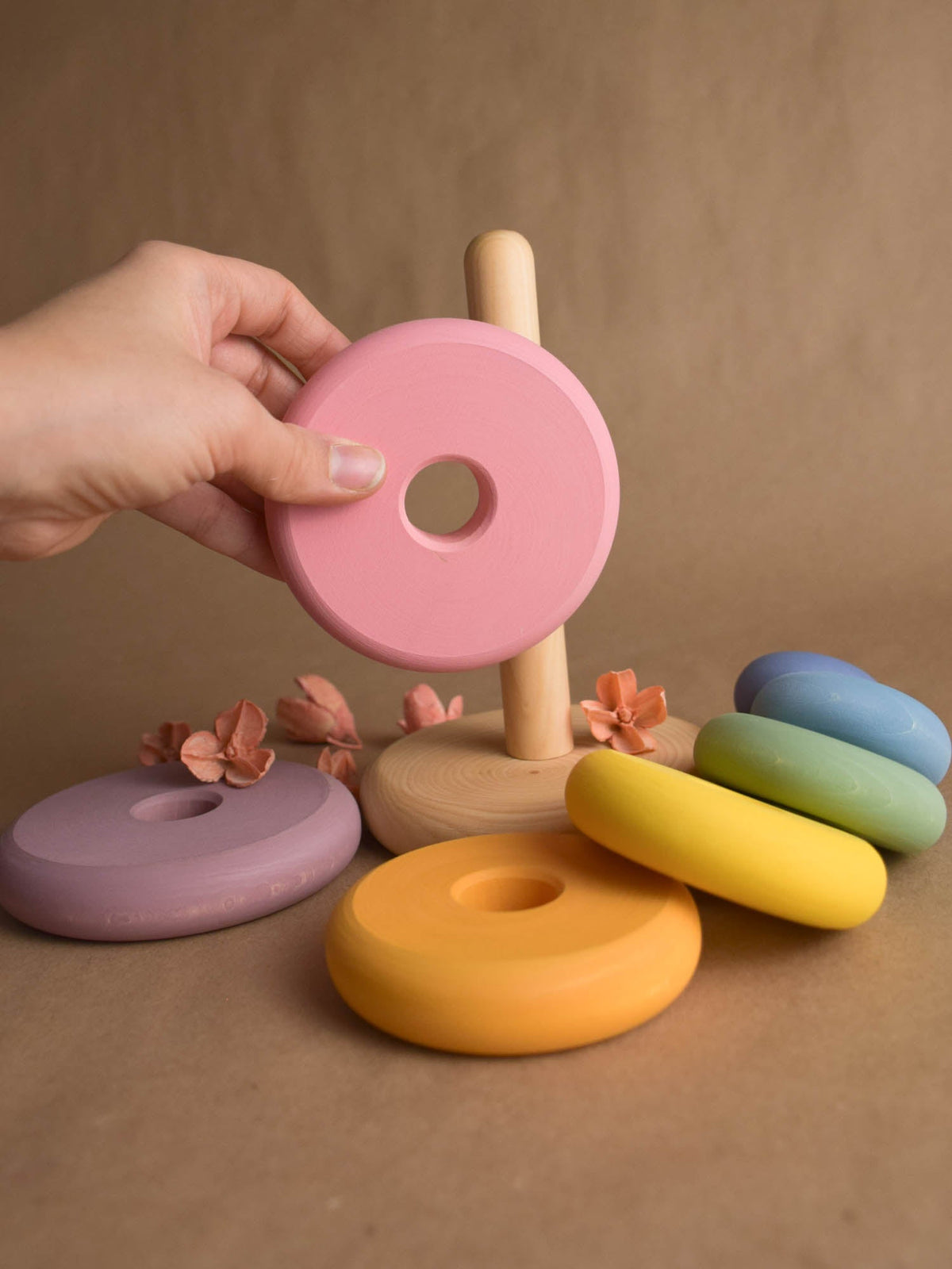 Linden wood stacking toy with pastel-colored turned rings