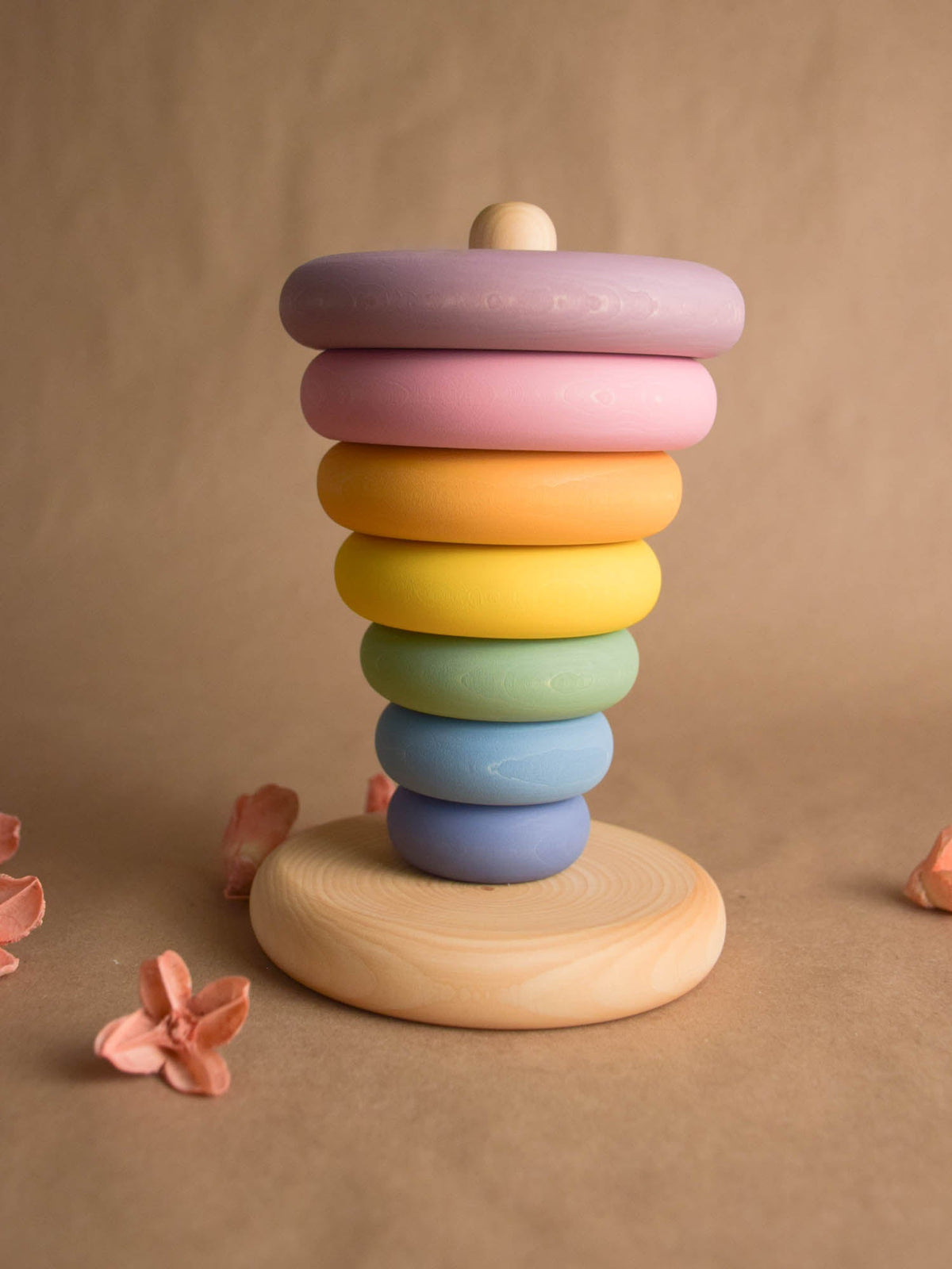 Stacking toy with pastel-colored turned rings made from linden wood