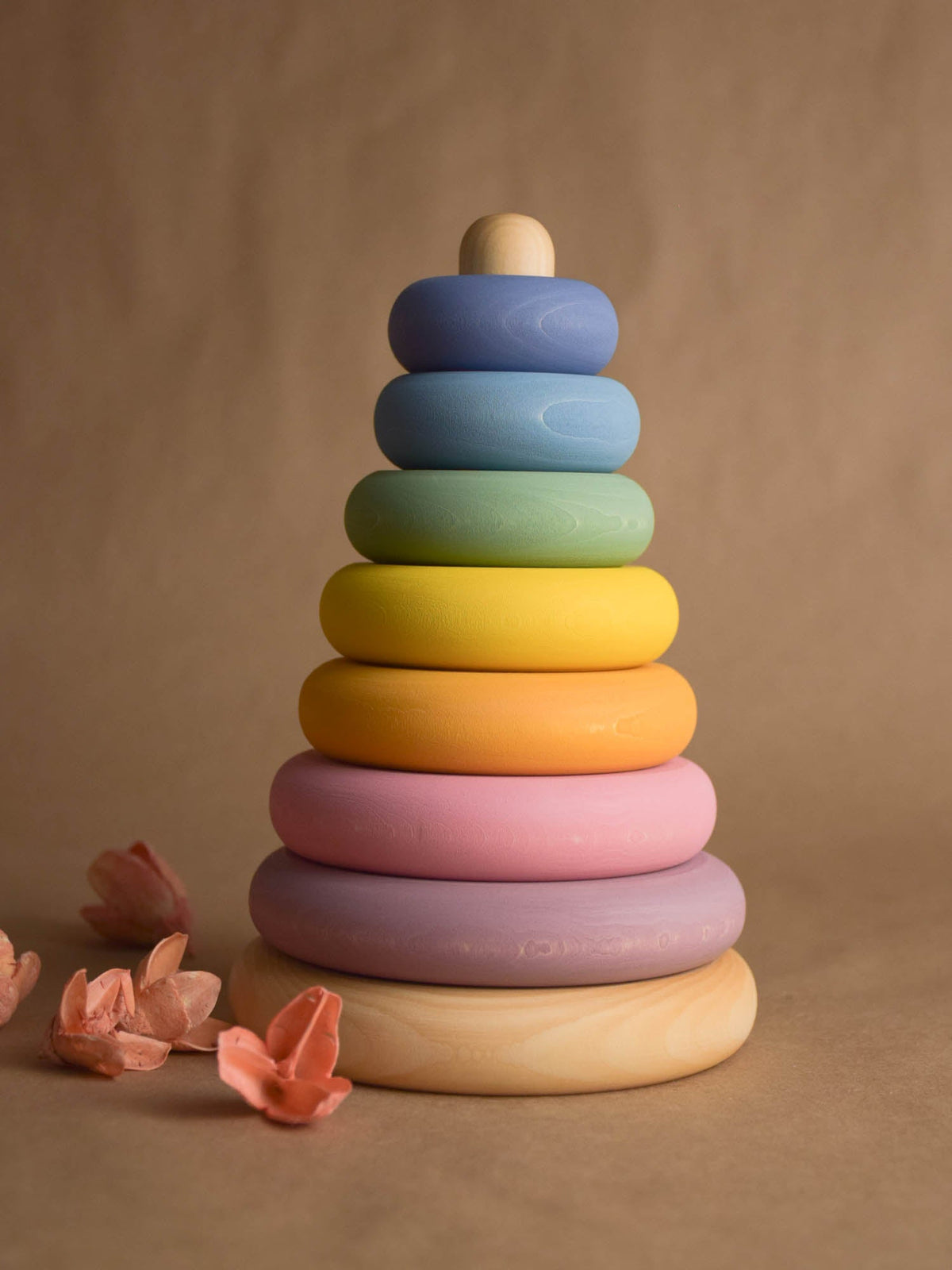 Linden wood stacking toy with pastel-colored turned rings