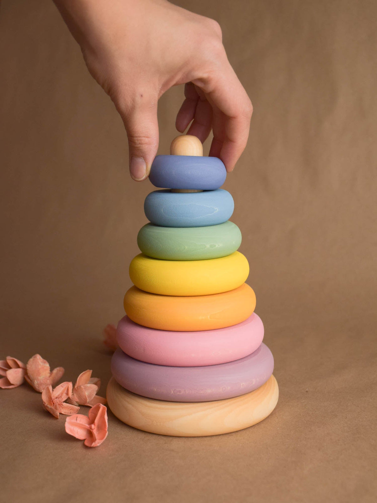 Ring stacking toy made from linden wood, with pastel-colored turned rings