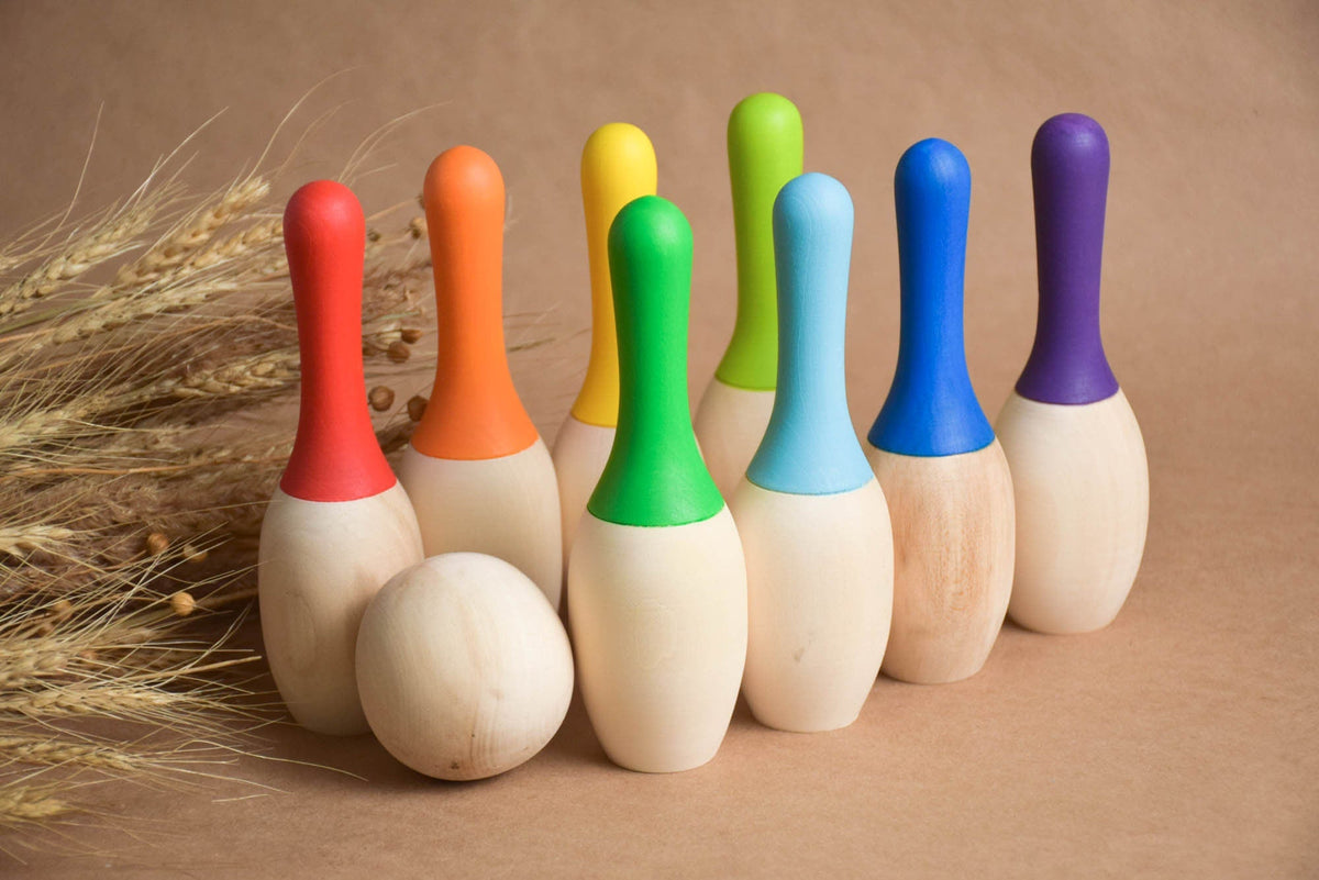 Rainbow-colored wooden skittles set