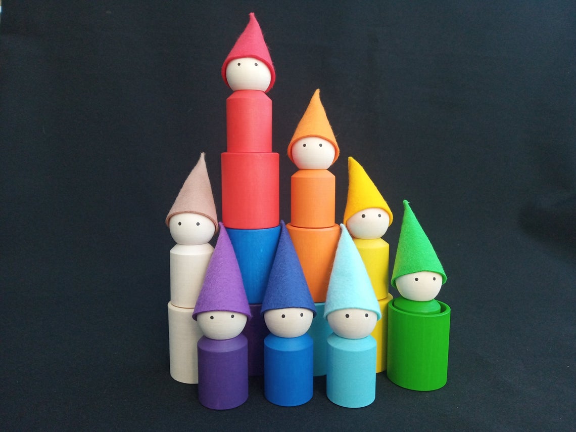 Colorful wooden cups and peg dolls with hats